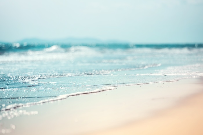 Close-up soft wave of the sea on the sandy beach